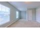 Bedroom with two windows for natural light, closet, and neutral carpet at 151 Braeside Ct, Cary, NC 27519