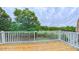 Beautiful wooden deck with white railings and lush green trees in the background at 151 Braeside Ct, Cary, NC 27519