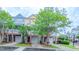 Townhome exterior featuring a brick facade, individual garages, and covered porches at 151 Braeside Ct, Cary, NC 27519