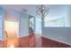 Spacious foyer features wood flooring, a modern light fixture and staircase leading to upper level at 151 Braeside Ct, Cary, NC 27519