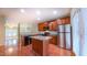 Well-equipped kitchen with stainless steel appliances, wood cabinetry, island and beautiful flooring at 151 Braeside Ct, Cary, NC 27519