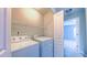 Bright laundry room with a washer, dryer, and wire shelving for storage at 151 Braeside Ct, Cary, NC 27519