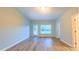 Bright living room featuring wood-look floors and neutral wall paint at 151 Braeside Ct, Cary, NC 27519