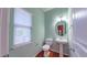 Cozy powder room features a pedestal sink, round mirror with vanity lighting, and a window bringing in natural light at 151 Braeside Ct, Cary, NC 27519