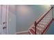 Light and bright staircase with wooden handrail and white risers at 151 Braeside Ct, Cary, NC 27519