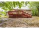 Backyard shot with a view of the house with deck and stairs to yard at 1510 Bungalow Ave, Durham, NC 27703