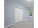 Bedroom showcases a closet, window and neutral carpet against blue walls at 1510 Bungalow Ave, Durham, NC 27703