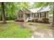 Attractive home showcasing lush greenery, colorful flowers, and a inviting walkway to the front door at 1510 Bungalow Ave, Durham, NC 27703