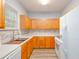 Well-lit kitchen features wood cabinets, white countertops and appliances at 1510 Bungalow Ave, Durham, NC 27703
