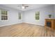 Spacious living room features laminate floors, three windows and fireplace at 1510 Bungalow Ave, Durham, NC 27703