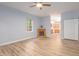 Open-concept living room with fireplace, laminate floors, and view of kitchen at 1510 Bungalow Ave, Durham, NC 27703