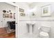 Elegant bathroom with white subway tiles, pedestal sink, and decorative mosaic tile flooring at 1535 Caraleigh Mills Ct # 111, Raleigh, NC 27603