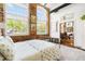 Bedroom boasts brick accent wall, oversized windows and view into the sitting room at 1535 Caraleigh Mills Ct # 111, Raleigh, NC 27603