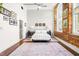Comfortable bedroom with natural light, exposed brick accent wall, and stylish decor at 1535 Caraleigh Mills Ct # 111, Raleigh, NC 27603