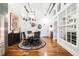 Charming dining area with chandelier, round marble table, and wood floors at 1535 Caraleigh Mills Ct # 111, Raleigh, NC 27603