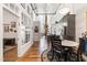 Open-concept kitchen and dining area with hardwood floors and modern lighting fixtures at 1535 Caraleigh Mills Ct # 111, Raleigh, NC 27603