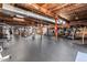 Spacious home gym featuring various workout machines and exposed brick accents at 1535 Caraleigh Mills Ct # 111, Raleigh, NC 27603