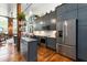 Modern kitchen with gray cabinets, stainless steel appliances, and hardwood floors at 1535 Caraleigh Mills Ct # 111, Raleigh, NC 27603