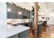 Bright, modern kitchen with gray cabinets, stainless appliances, and a rustic wooden support beam at 1535 Caraleigh Mills Ct # 111, Raleigh, NC 27603