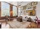 Sunlit living room featuring exposed brick, arched windows, and eclectic art wall at 1535 Caraleigh Mills Ct # 111, Raleigh, NC 27603