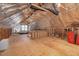Unfinished attic space with exposed wooden beams and a window, ready for your custom design at 1605 Baneberry Ct, Willow Springs, NC 27592