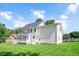 Spacious backyard featuring a large deck, manicured lawn, and bright white siding and trim at 1605 Baneberry Ct, Willow Springs, NC 27592