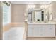 Well-lit bathroom with double vanity, garden tub, and neutral color palette at 1605 Baneberry Ct, Willow Springs, NC 27592