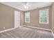 Comfortable bedroom featuring soft carpeting, two bright windows, and a convenient closet door at 1605 Baneberry Ct, Willow Springs, NC 27592