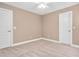 Inviting bedroom with neutral walls, plush carpeting, and two entry doors for easy access at 1605 Baneberry Ct, Willow Springs, NC 27592