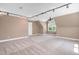 Large bonus room with neutral carpet and track lighting perfect for recreation or media at 1605 Baneberry Ct, Willow Springs, NC 27592