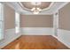 Bright dining room featuring wainscoting, hardwood floors and a modern light at 1605 Baneberry Ct, Willow Springs, NC 27592