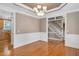 Dining room with wainscoting, hardwood floors and a modern light fixture at 1605 Baneberry Ct, Willow Springs, NC 27592