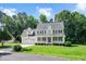 Charming two-story home with a well-manicured lawn and a classic white porch at 1605 Baneberry Ct, Willow Springs, NC 27592