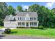 Charming two-story home featuring a welcoming front porch, well-manicured lawn, and a two-car garage at 1605 Baneberry Ct, Willow Springs, NC 27592