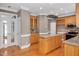 Stylish kitchen with light wood cabinets, granite countertops, and stainless steel appliances at 1605 Baneberry Ct, Willow Springs, NC 27592