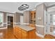 Spacious kitchen features an island with granite countertops and a pot rack above at 1605 Baneberry Ct, Willow Springs, NC 27592