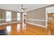 Bright living room featuring hardwood floors and large windows, creating a warm atmosphere at 1605 Baneberry Ct, Willow Springs, NC 27592