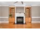 Elegant living room featuring a fireplace flanked by custom built-in shelving and cabinets at 1605 Baneberry Ct, Willow Springs, NC 27592