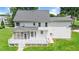 Back of house with screened porch, deck, and spacious backyard ideal for relaxation and entertainment at 1605 Baneberry Ct, Willow Springs, NC 27592