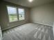 A cozy bedroom features neutral walls, carpet, and a double window at 170 Starry Sky Dr, Benson, NC 27504
