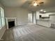 Open-concept living room featuring a fireplace and seamless flow into the kitchen at 170 Starry Sky Dr, Benson, NC 27504