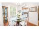 Charming dining room with glass table, white chairs and ample natural light at 1700 Tiffany Bay Ct # 303, Raleigh, NC 27609