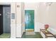 Welcoming entryway with green door, decorative flower arrangement, and elevator access at 1700 Tiffany Bay Ct # 303, Raleigh, NC 27609