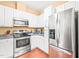 Charming kitchen with stainless steel appliances, white cabinetry and solid surface countertops at 1700 Tiffany Bay Ct # 303, Raleigh, NC 27609