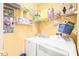 Functional laundry room with washer, dryer, and shelving for storage at 1700 Tiffany Bay Ct # 303, Raleigh, NC 27609