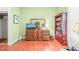 Cozy living room with hardwood floors, wooden dresser, mirror, and bookshelf filled with books at 1700 Tiffany Bay Ct # 303, Raleigh, NC 27609