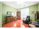 Comfortable living room features a reading chair, hardwood floors, and a bookshelf filled with books at 1700 Tiffany Bay Ct # 303, Raleigh, NC 27609