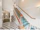 Elegant stairwell with green carpet, white trim and decorative tile flooring at 1700 Tiffany Bay Ct # 303, Raleigh, NC 27609