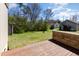 View of the backyard featuring a wooden deck and a grassy lawn at 1809 Coltrane Ct, Raleigh, NC 27610