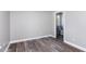 Cozy bedroom featuring wood-look floors, neutral paint, and a view to the bathroom at 1809 Coltrane Ct, Raleigh, NC 27610